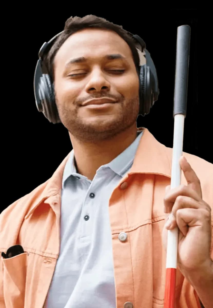 Man with headphones and white cane smiling towards camera.