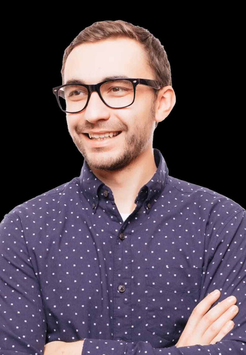 Man standing with arms crossed smiling at camera.